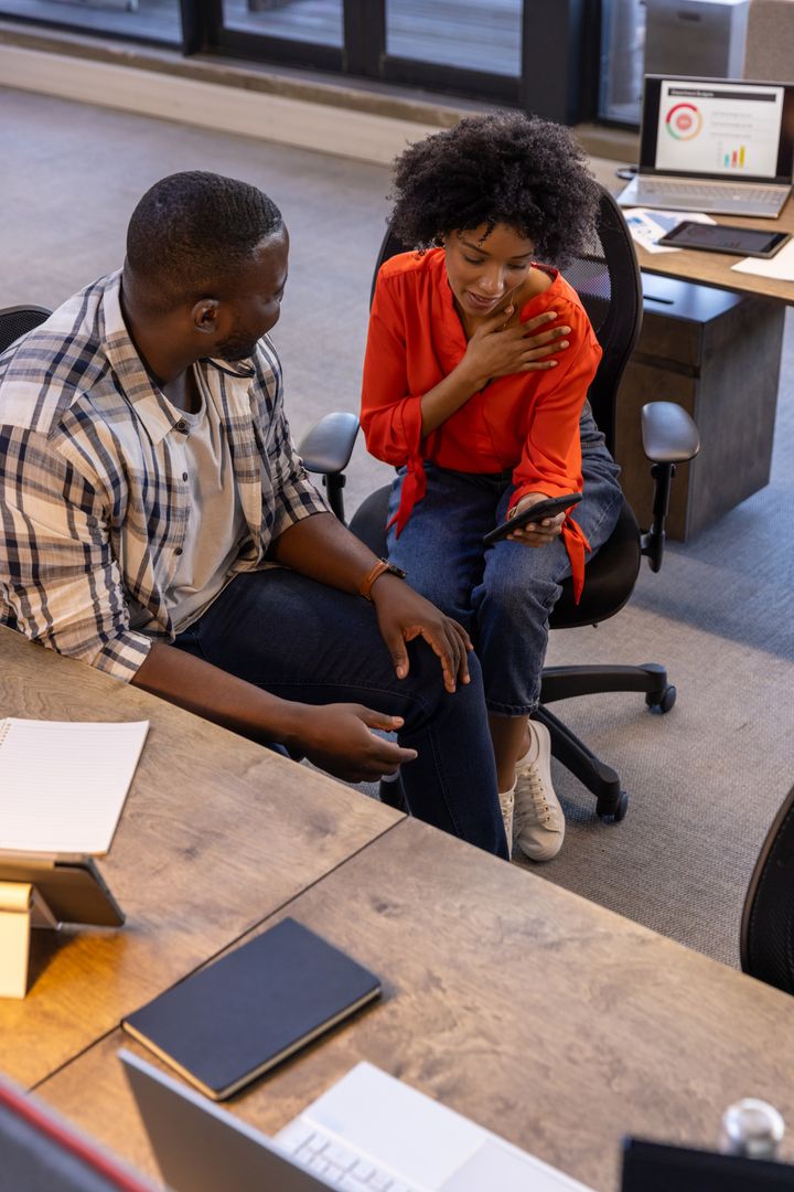 Supportive Colleagues Sharing Ideas in Modern Office Environment