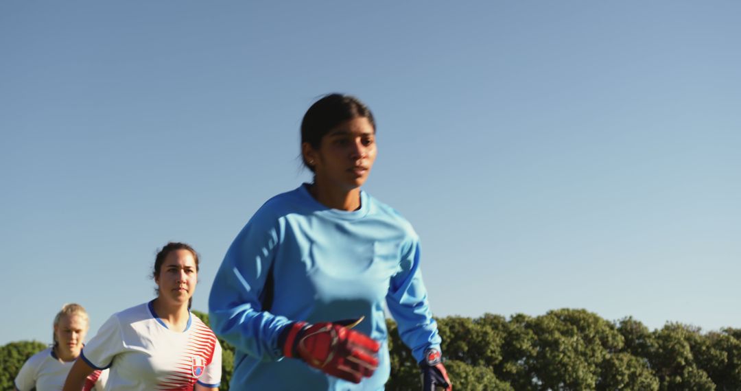 Diverse Female Soccer Players Practicing on Sunny Field