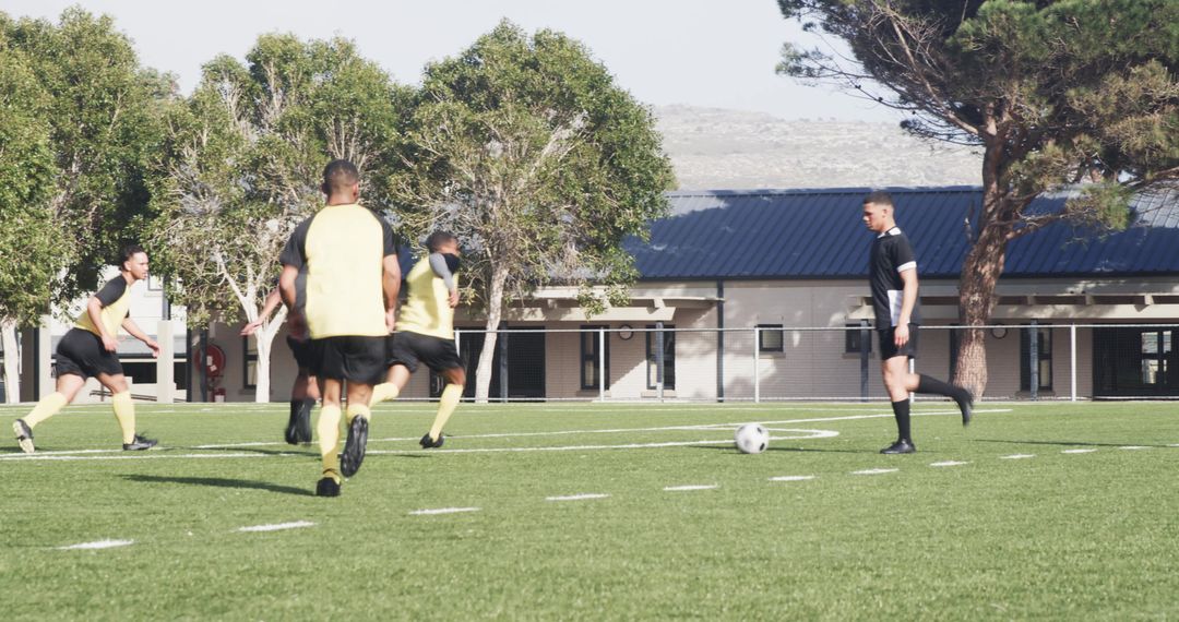 Soccer Players Practicing Teamwork on Sunny Field