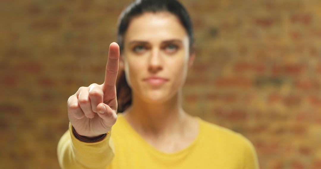 Woman pointing finger forward in focused concentration - Free Images, Stock Photos and Pictures on Pikwizard.com