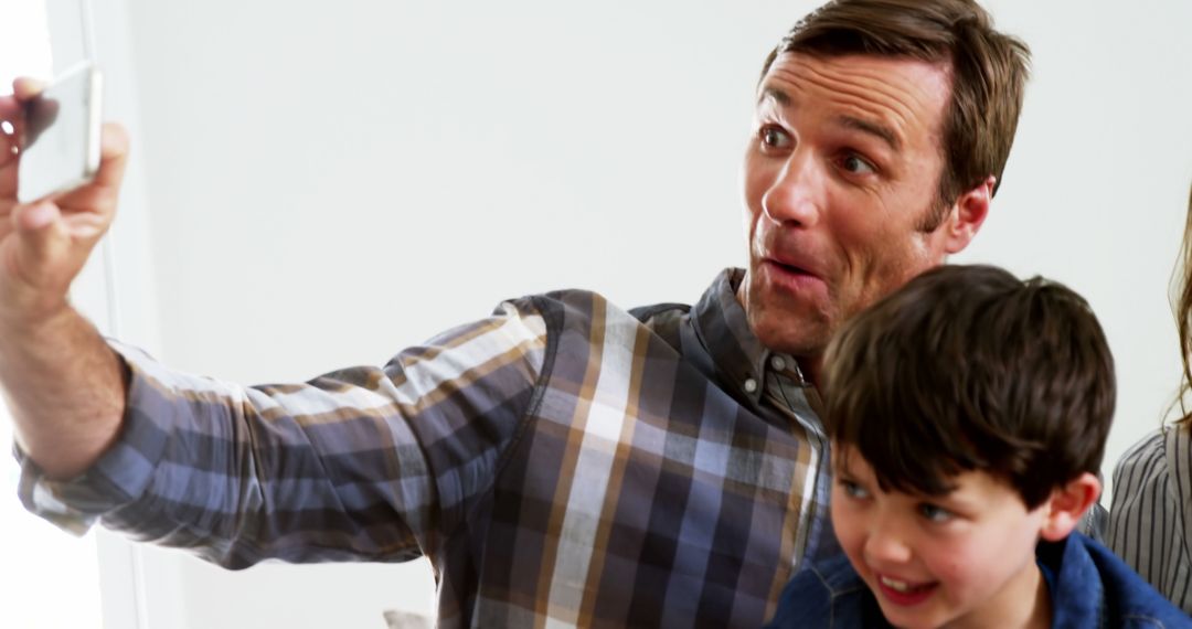 Father and Son Taking Selfie with Excited Facial Expressions - Free Images, Stock Photos and Pictures on Pikwizard.com