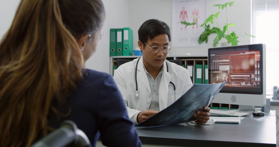 Doctor reviewing X-ray with patient in modern medical office - Free Images, Stock Photos and Pictures on Pikwizard.com