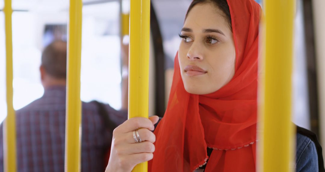 Young woman in a red hijab rides public transportation, with copy space - Free Images, Stock Photos and Pictures on Pikwizard.com