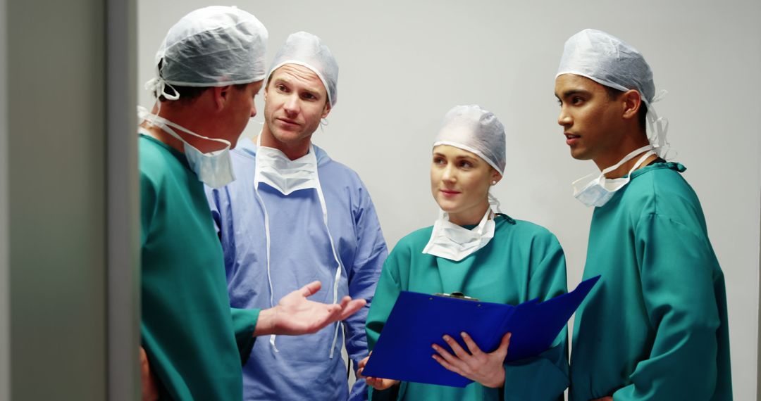 Medical Team Discussing Patient Care in Hospital - Free Images, Stock Photos and Pictures on Pikwizard.com