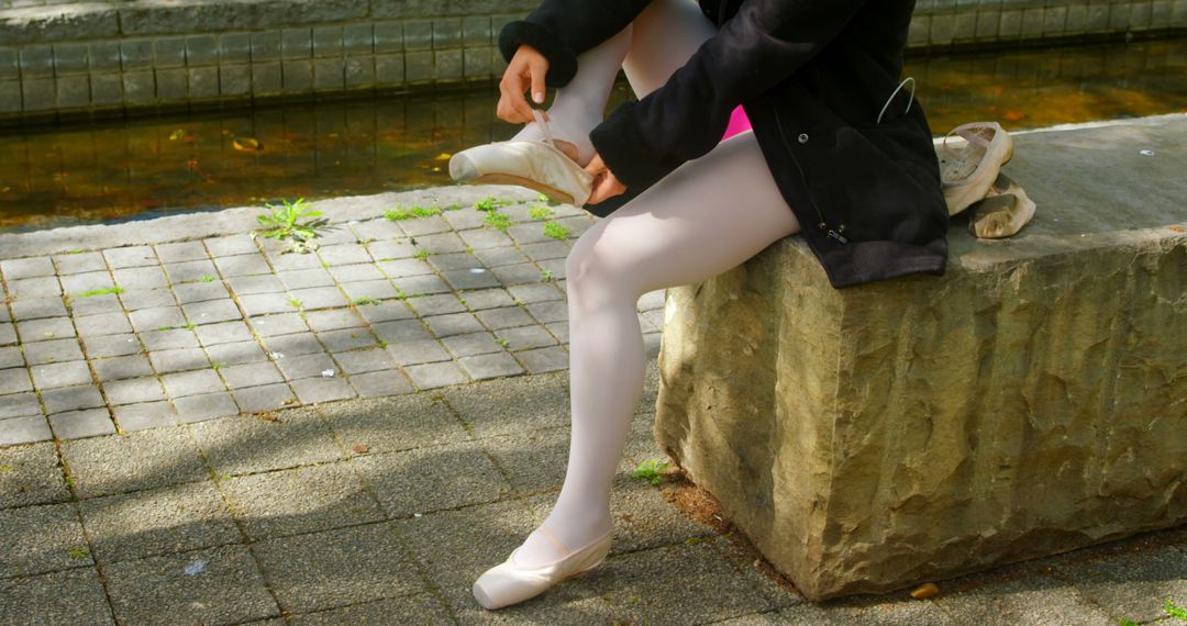 Low section of female ballerina wearing ballet shoe in the park - Free Images, Stock Photos and Pictures on Pikwizard.com