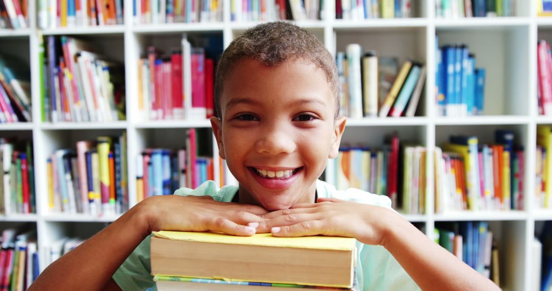 Smiling Boy Holding Stack of Books at Library - Free Images, Stock Photos and Pictures on Pikwizard.com