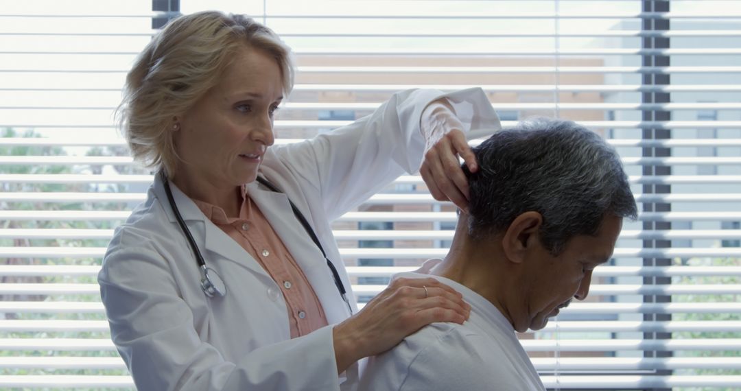 Doctor Examining Patient's Neck in Modern Clinic - Free Images, Stock Photos and Pictures on Pikwizard.com