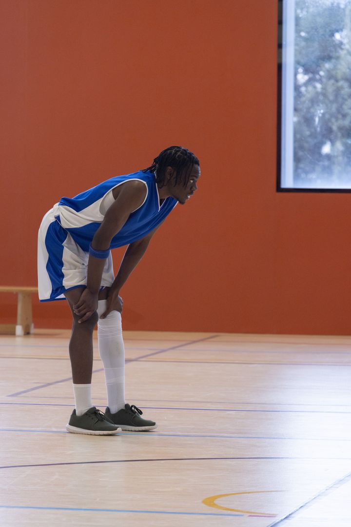 Intense Basketball Player Focused during Indoor Game