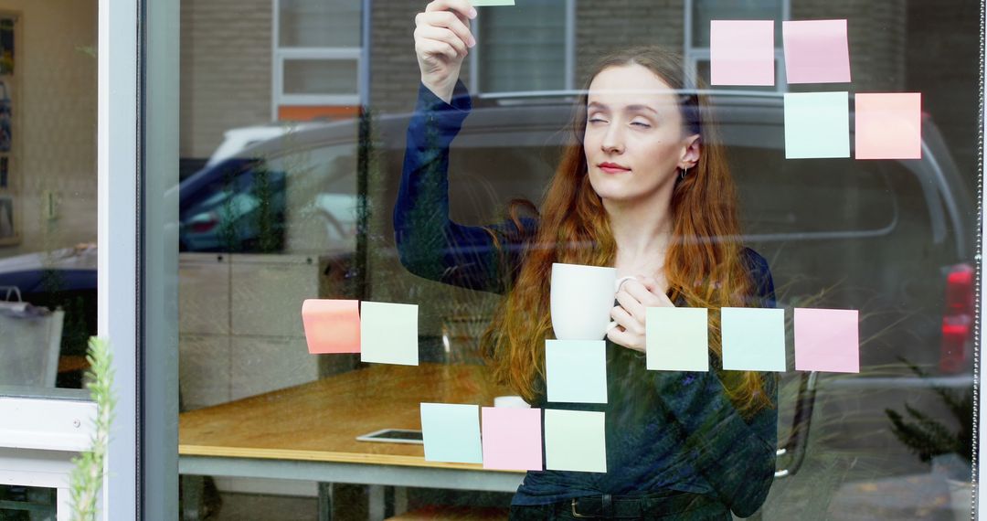 Woman Organizing Sticky Notes on a Glass Surface - Free Images, Stock Photos and Pictures on Pikwizard.com