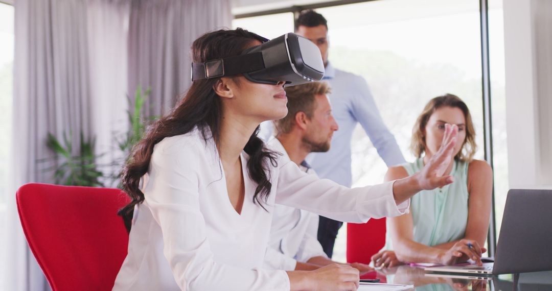 Businesswoman Using Virtual Reality in Office Meeting - Free Images, Stock Photos and Pictures on Pikwizard.com