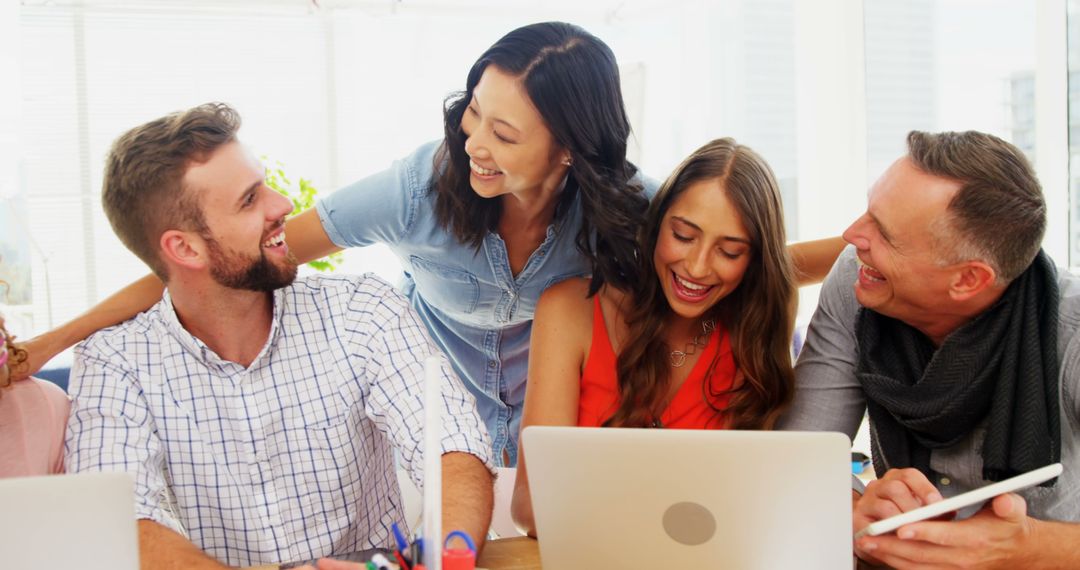 Diverse Group Enjoying Collaborative Work in Office Setting