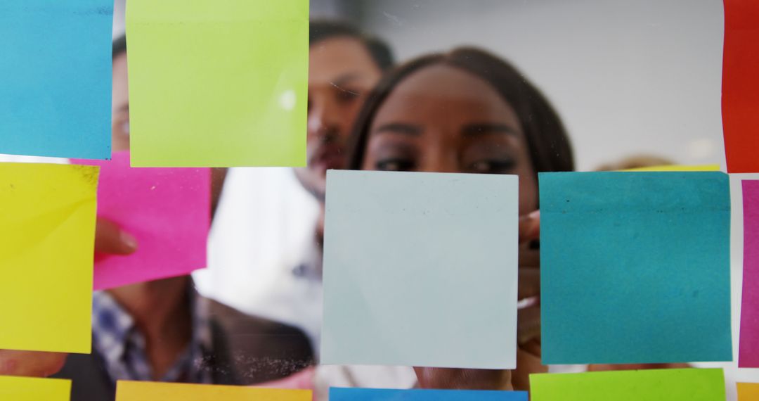 Multiracial Team Brainstorming with Colorful Sticky Notes on Glass Wall - Free Images, Stock Photos and Pictures on Pikwizard.com