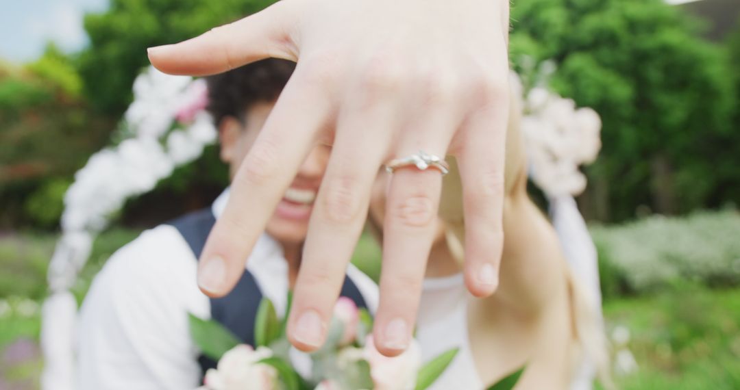 Happy Couple at Outdoor Wedding Showing Engagement Ring