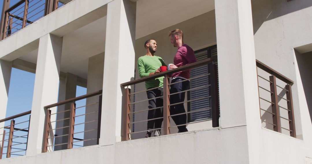 Two Men Chatting on Modern Building Balcony - Free Images, Stock Photos and Pictures on Pikwizard.com