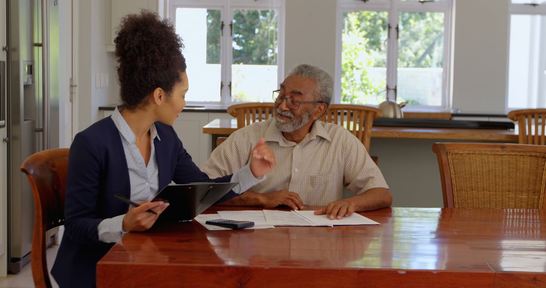 Financial Advisor Discussing Investment Plans with Senior Client - Free Images, Stock Photos and Pictures on Pikwizard.com