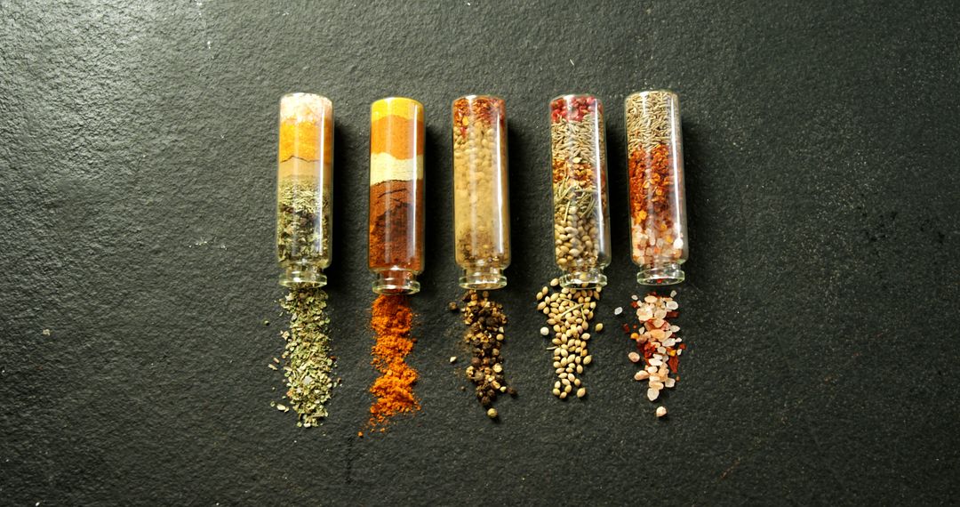 Assortment of Spices in Glass Tubes on Black Surface - Free Images, Stock Photos and Pictures on Pikwizard.com