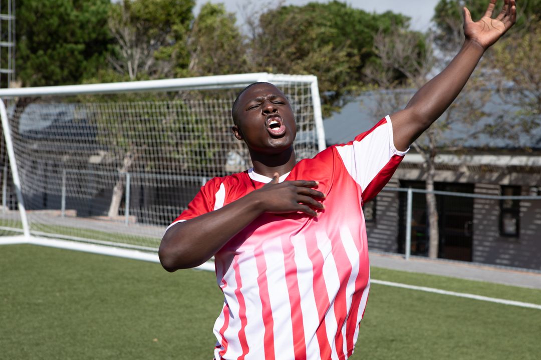 Excited Soccer Player Celebrating Victory on Field