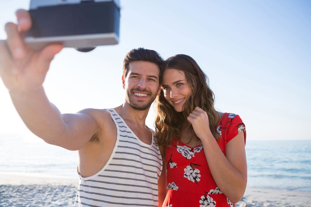 Happy Couple Taking Selfie at Beach on Sunny Day - Free Images, Stock Photos and Pictures on Pikwizard.com