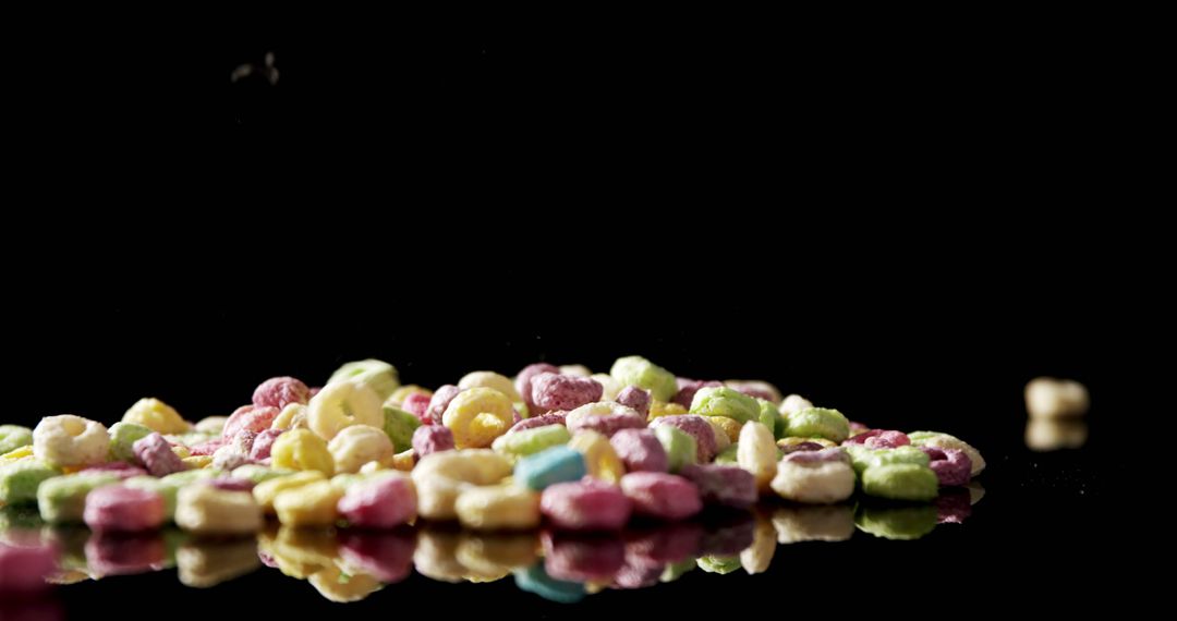 Colorful Cheerios Piled on Reflective Surface - Free Images, Stock Photos and Pictures on Pikwizard.com