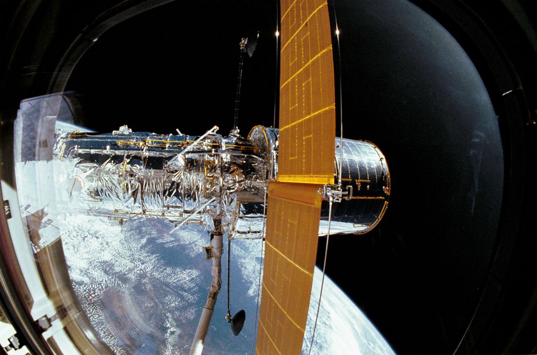 Hubble Space Telescope Docked with Space Shuttle Discovery During 1990 Mission - Free Images, Stock Photos and Pictures on Pikwizard.com