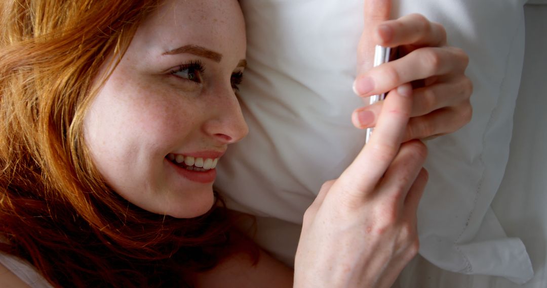 Smiling Redheaded Woman Using Smartphone in Bed - Free Images, Stock Photos and Pictures on Pikwizard.com