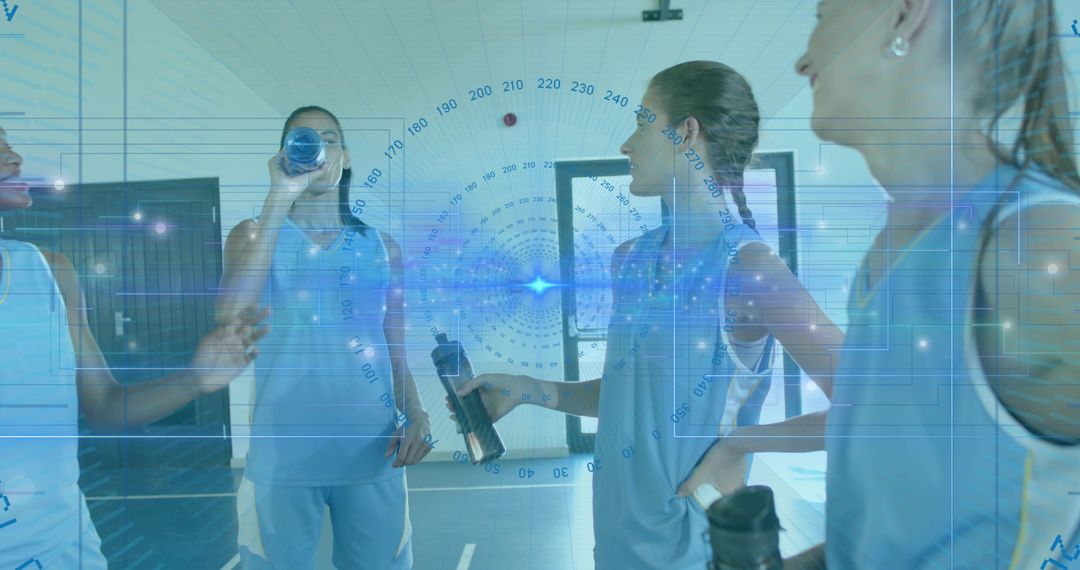 Female athletes chatting and hydrating while holding water bottles in gym corridor with HUD overlay