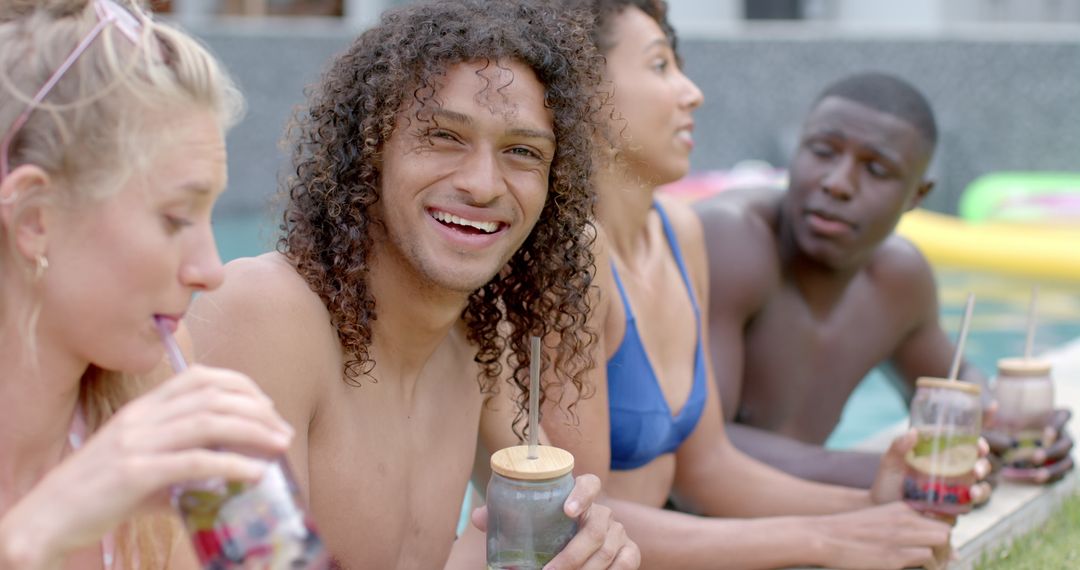 Diverse Group Enjoying Poolside Drinks on Sunny Day