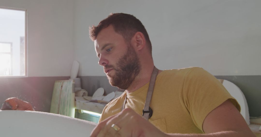 Focused Potter Shaping Clay in Bright Studio