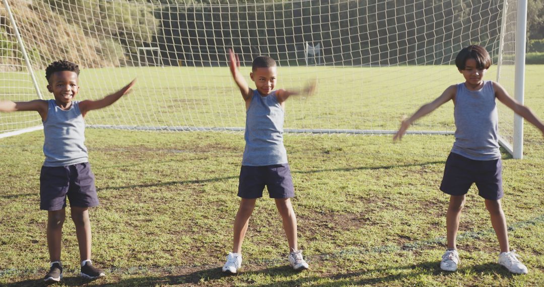 Children Exercising with Joy on Soccer Field Enjoying Teamwork