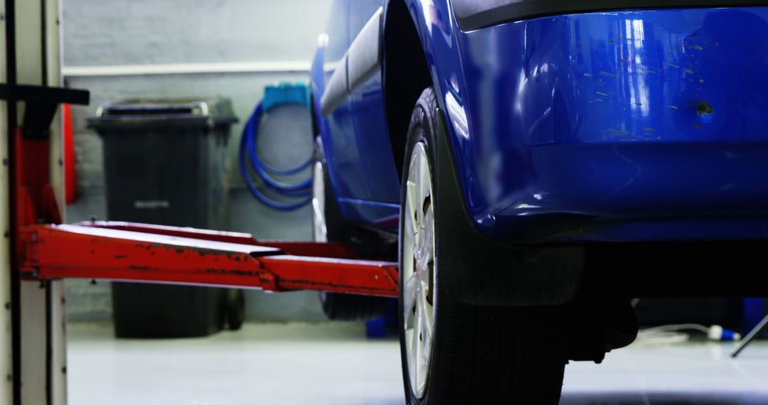 Blue Car on Lift in Garage Workshop for Maintenance - Free Images, Stock Photos and Pictures on Pikwizard.com