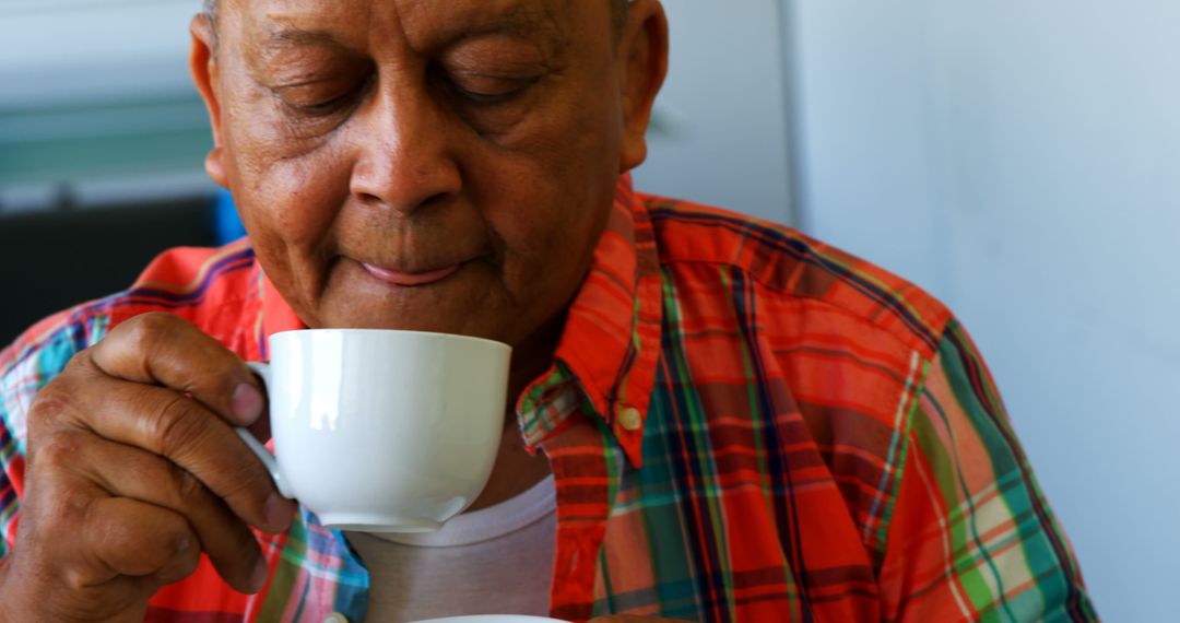 Elderly Man Enjoying Morning Coffee in a Plaid Shirt - Free Images, Stock Photos and Pictures on Pikwizard.com