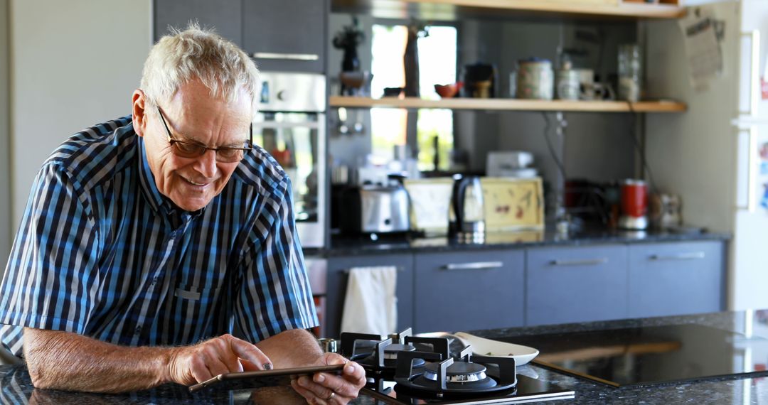 Senior Man Using Tablet in Modern Kitchen - Free Images, Stock Photos and Pictures on Pikwizard.com