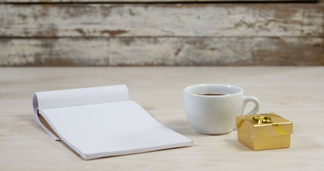 Golden Gift Box With Cup of Coffee and Blank Paper Notebook - Free Images, Stock Photos and Pictures on Pikwizard.com