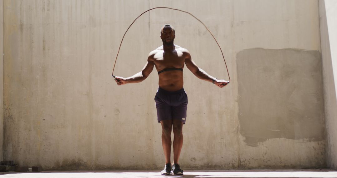 Fit Man Jumping Rope in Urban Setting - Free Images, Stock Photos and Pictures on Pikwizard.com