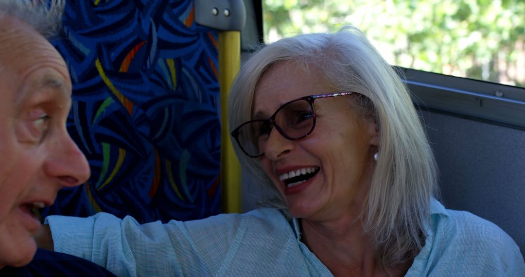 Senior Woman Laughing on a Bus with Companion - Free Images, Stock Photos and Pictures on Pikwizard.com