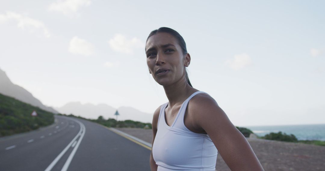 Female Athlete Taking Break Roadside After Run - Free Images, Stock Photos and Pictures on Pikwizard.com