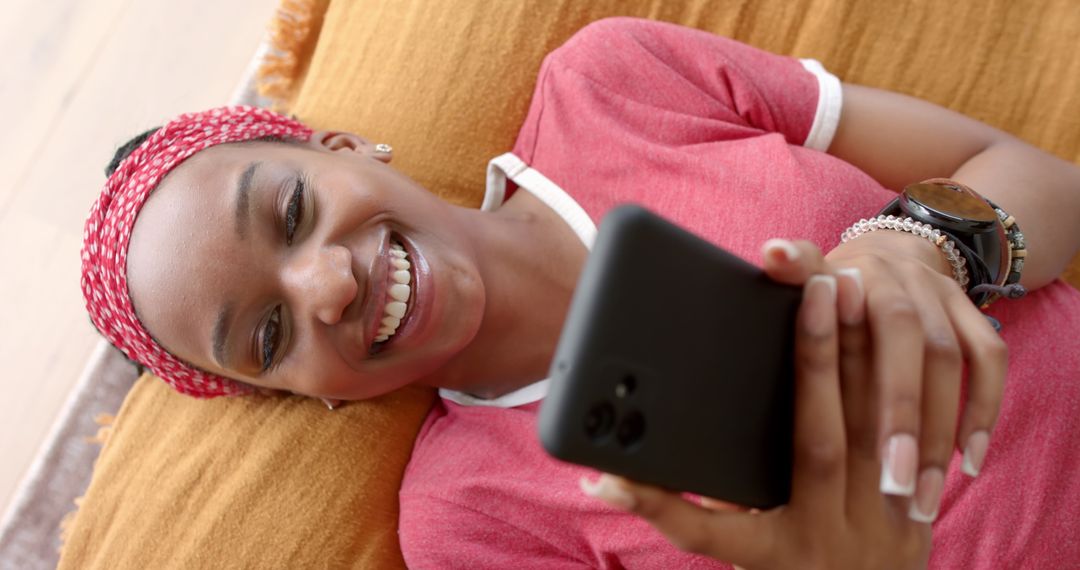 Smiling Young Woman Enjoying Smartphone at Home