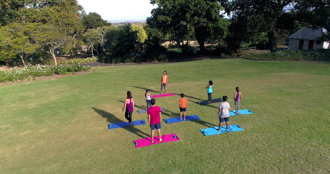 Diverse Group Practicing Outdoor Yoga in Serene Park Setting - Free Images, Stock Photos and Pictures on Pikwizard.com