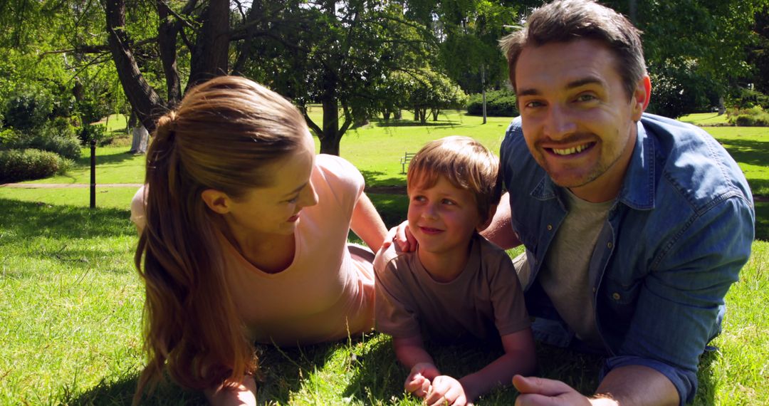 Happy Family Lying on Grass in Sunny Park - Free Images, Stock Photos and Pictures on Pikwizard.com