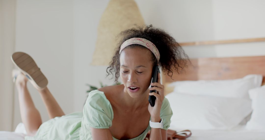 Woman Relaxing on Bed Talking on Smartphone in Leisure Setting