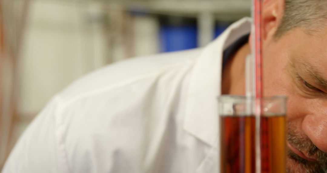 Scientist Examining Liquid in Graduated Cylinder in Laboratory - Free Images, Stock Photos and Pictures on Pikwizard.com