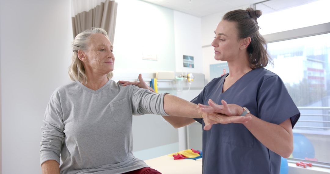 Physical Therapist Assisting Senior Woman With Arm Mobility Exercises - Free Images, Stock Photos and Pictures on Pikwizard.com