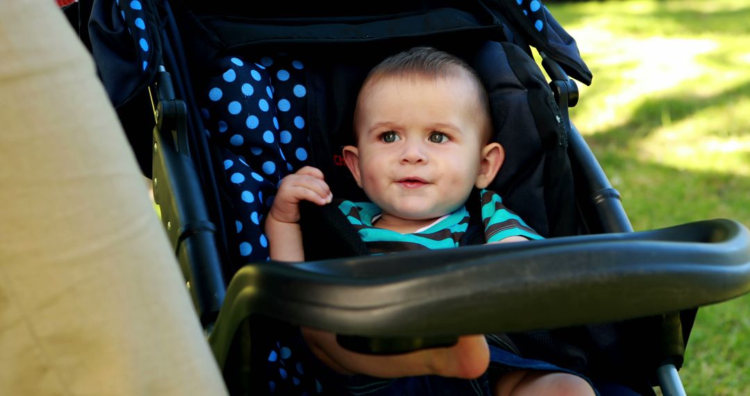 Adorable Baby Boy Relaxing in Stroller on Sunny Day