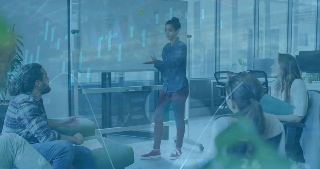 Diverse Team Engaged in Office Strategy Meeting with Financial Overlay