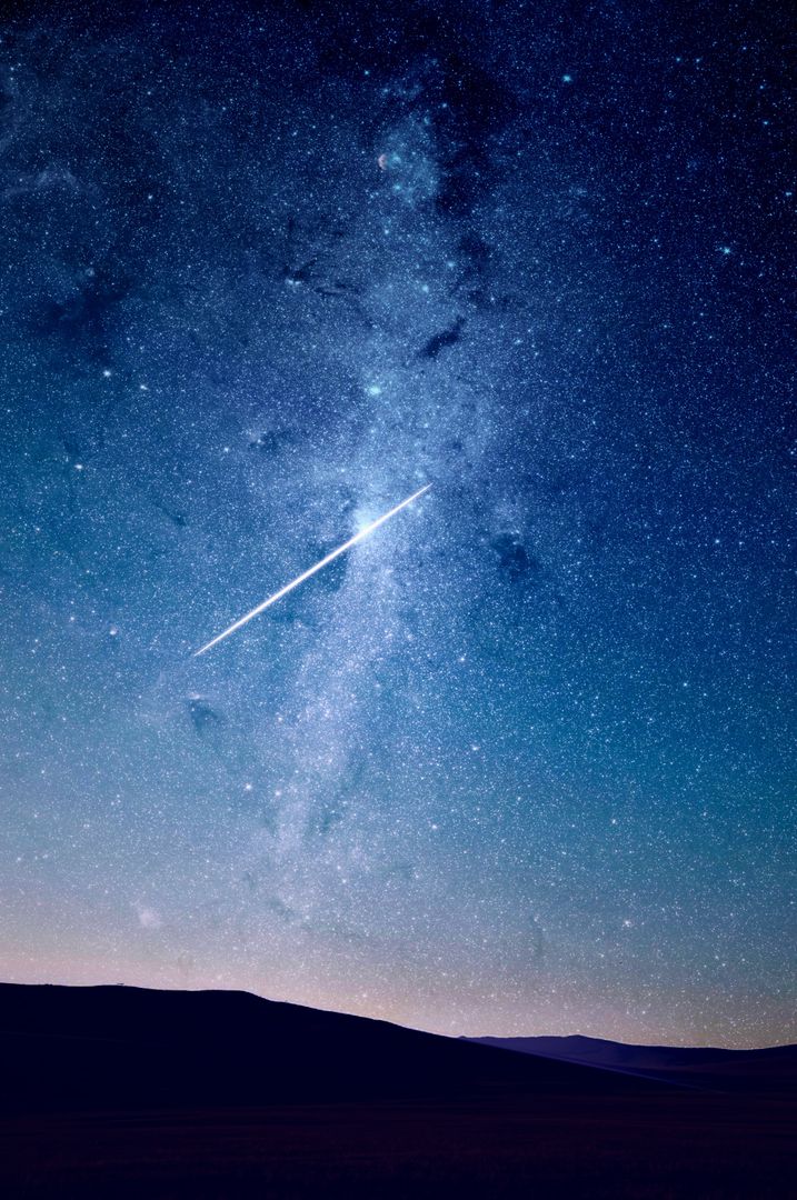 Bright Meteor in a Starry Sky Over a Dark Horizon - Free Images, Stock Photos and Pictures on Pikwizard.com