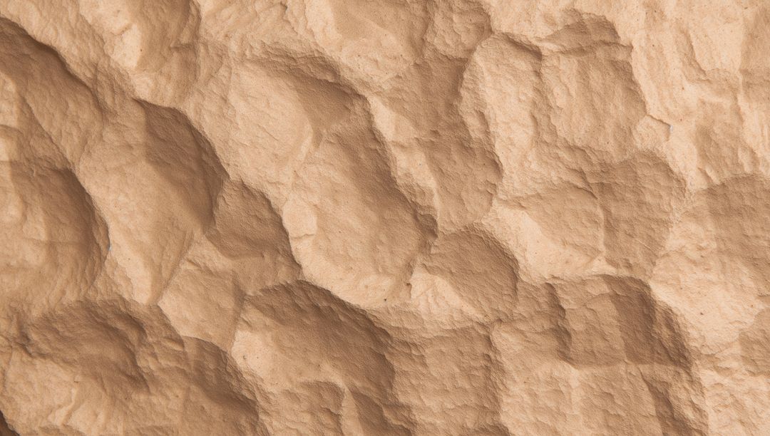 Macro Sandstone Relief Texture Showing Rounded Depressions and Ridges with Soft Sidelight