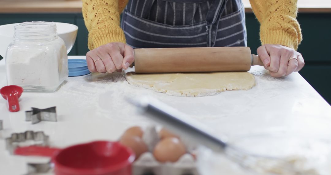 Person Rolling Dough on White Countertop Wearing Striped Apron - Free Images, Stock Photos and Pictures on Pikwizard.com