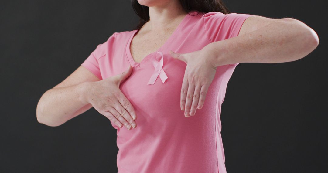 Woman Displaying Breast Cancer Awareness Ribbon on Pink T-Shirt - Free Images, Stock Photos and Pictures on Pikwizard.com