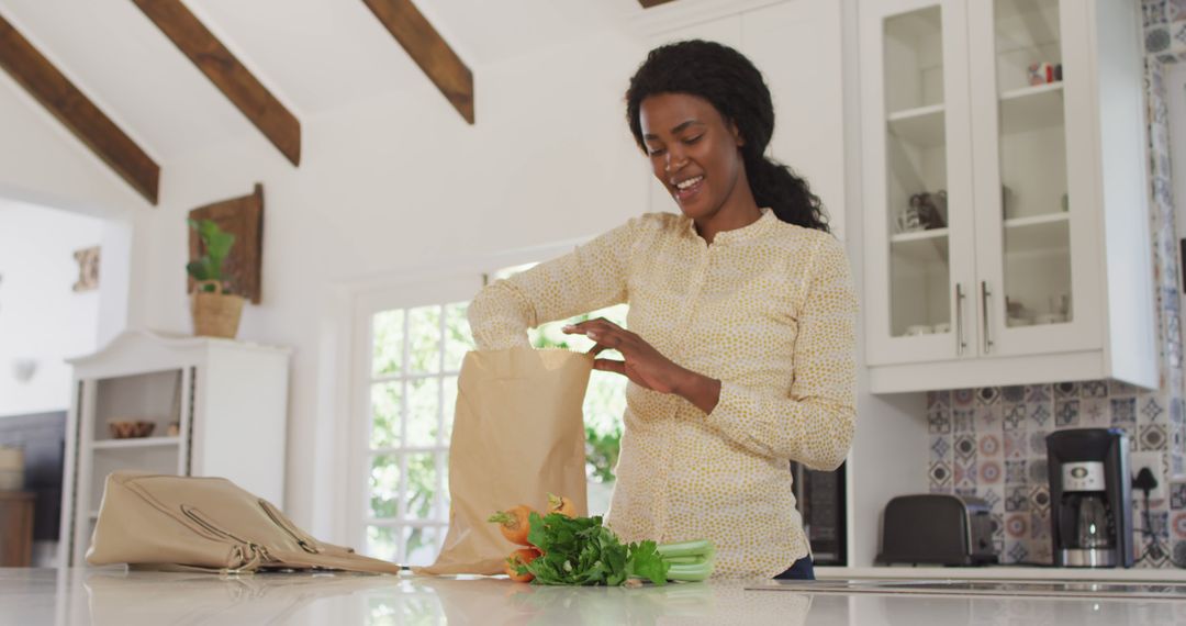 African American Woman Unpacking Groceries in Kitchen - Free Images, Stock Photos and Pictures on Pikwizard.com