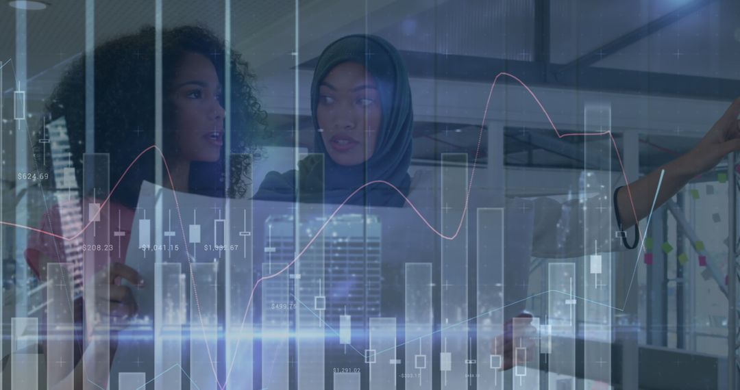 Digital Graphs Overlaying Focused Businesswomen in Financial Discussion